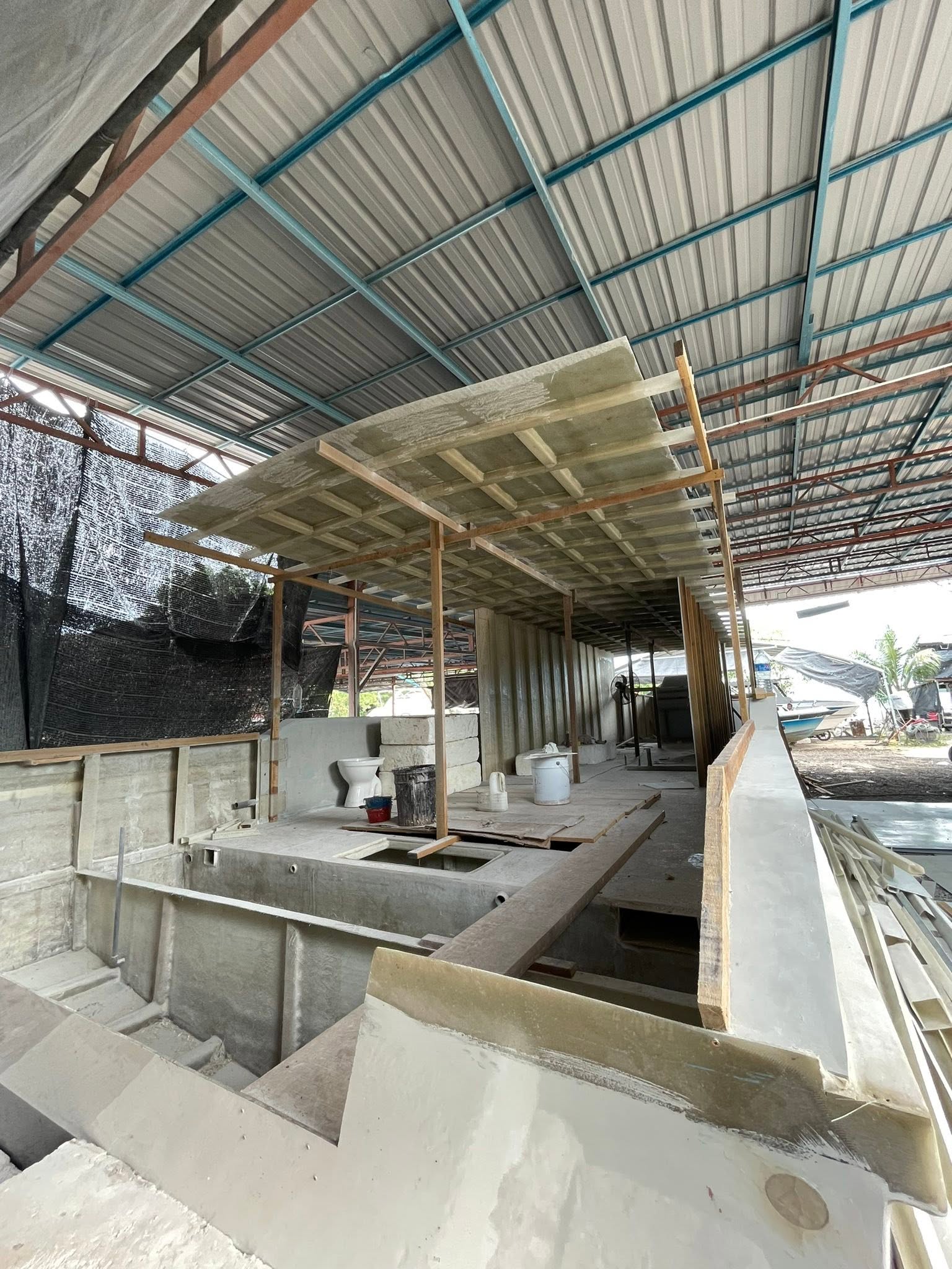 Deck, cabin and roof structure being fabricated inside a working vessel