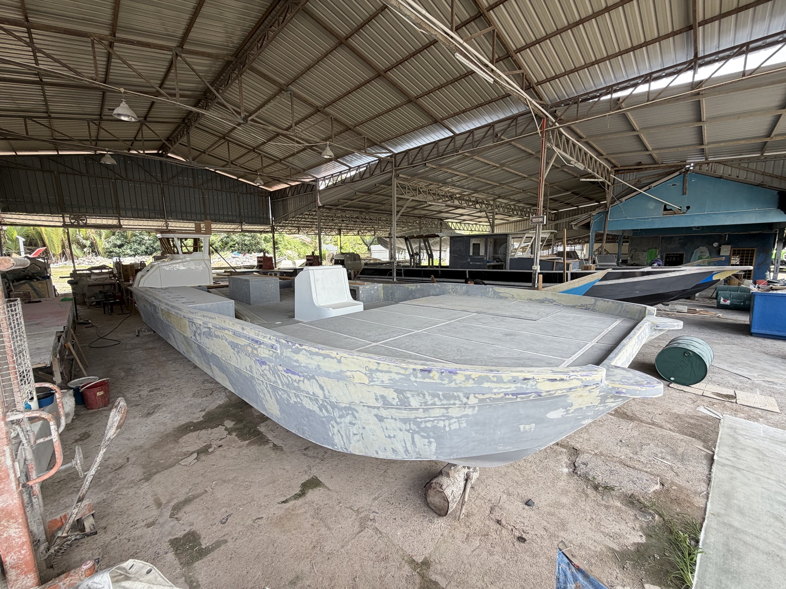 Side view of the catamaran during fairing and surface preparation