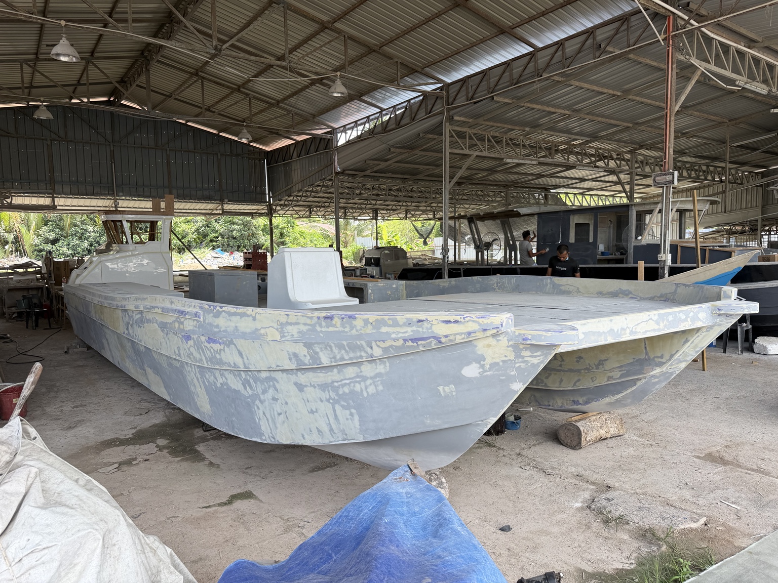 Wide-deck catamaran project under construction in the boatyard